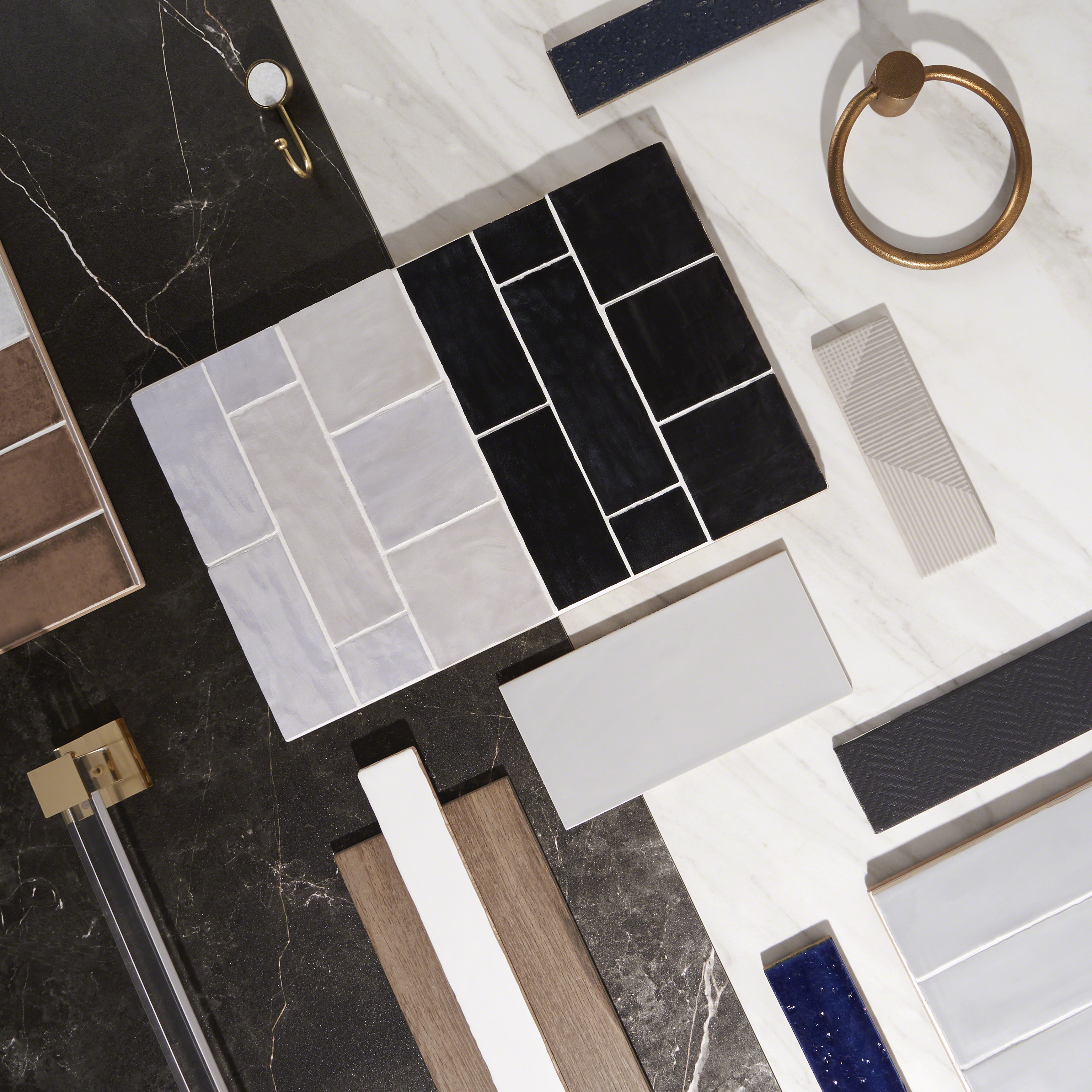 Marble and Brass tile examples next to towel hooks and toilet roll holders / hangers to show colour pallet 