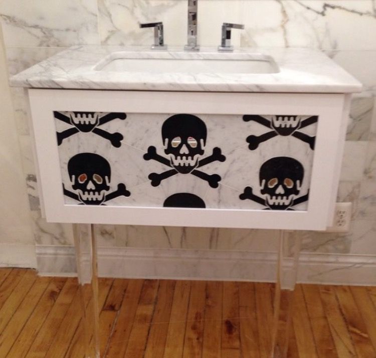 Live Free Marble & Mirror Tile shown on a sink unit. The live free design is a large black skull and crossbones with mirrored eyes. 
