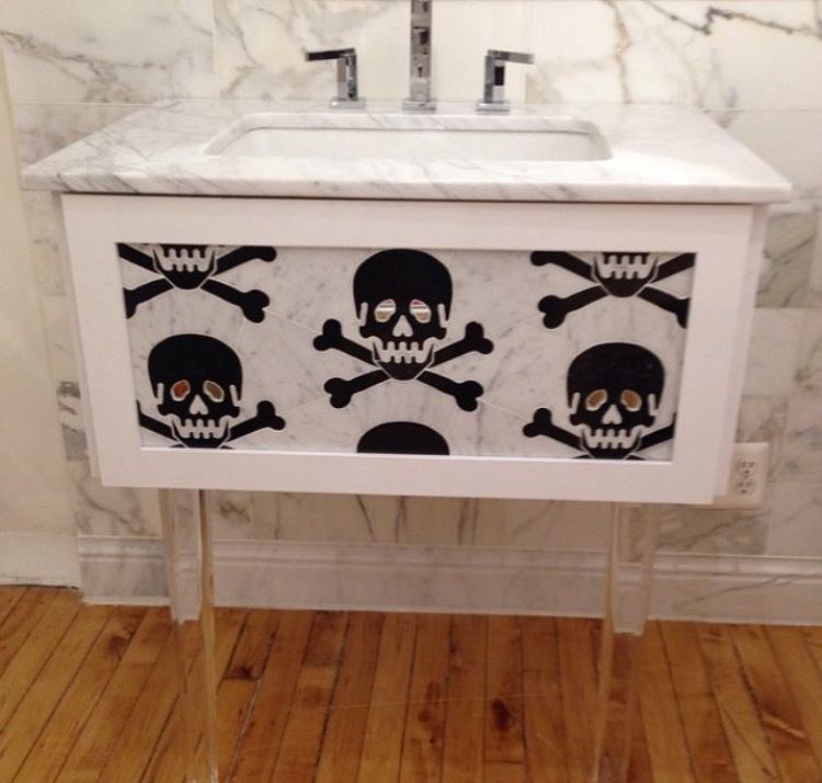 Live Free Marble & Mirror Tile shown on a sink unit. The live free design is a large black skull and crossbones with mirrored eyes.