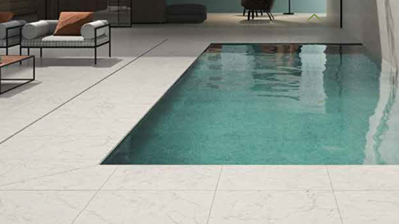 Swimming pool tiles example in the pool with marble look floor tiles around